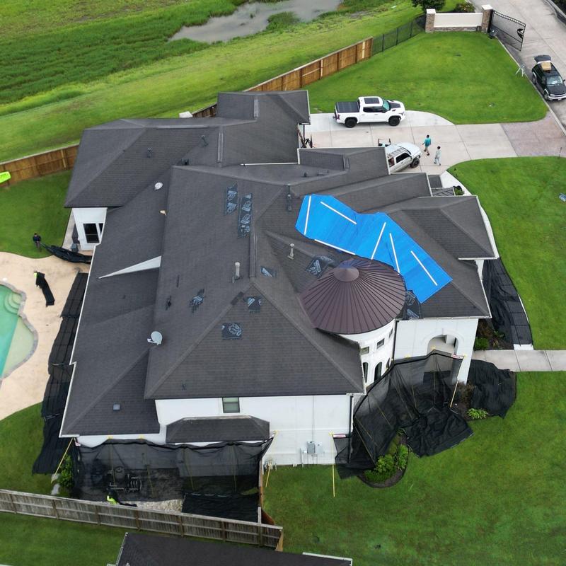 Tamko Titan XT roof with blue tarp after storm damage Tamko Titan XT roof with blue tarp after storm damage