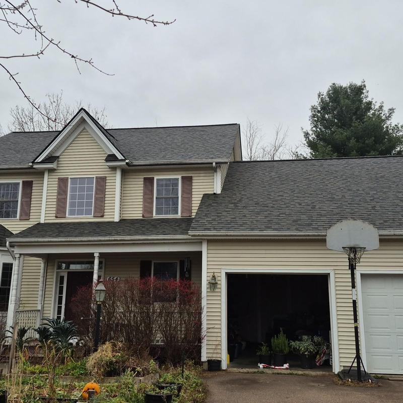 Shingle roof on two-story house with garage and basketball hoop