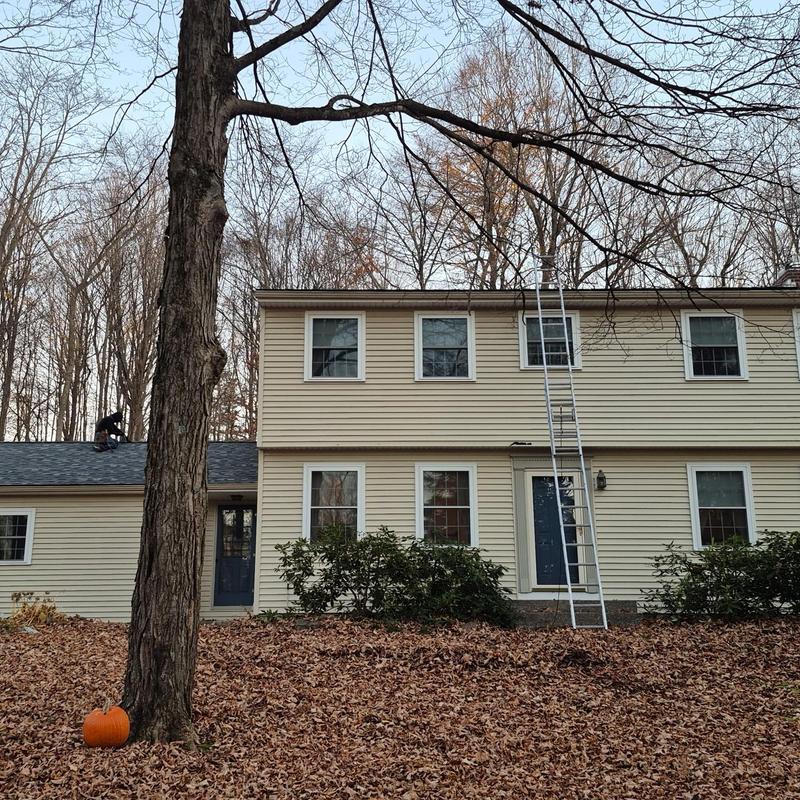 Shingle roof installation on two-story home exterior