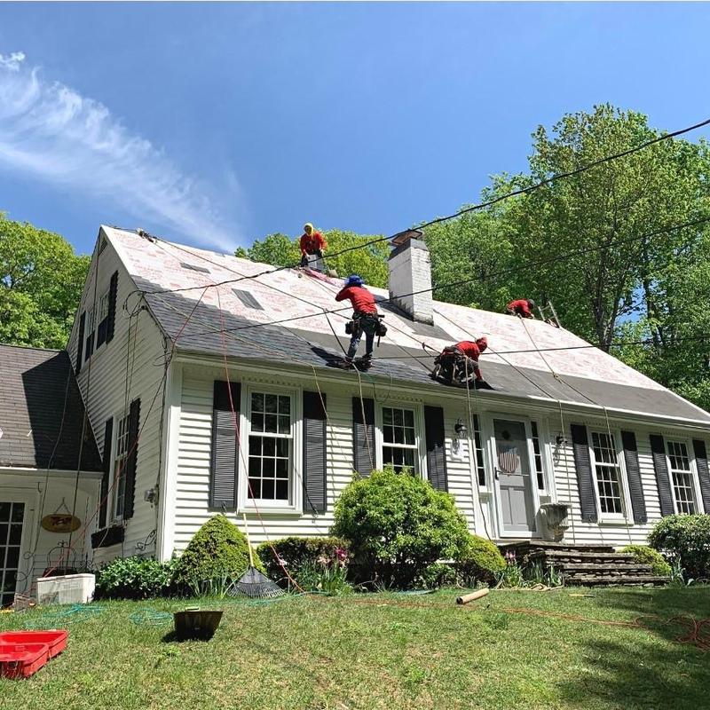Shingle roof installation on white house in Vermont