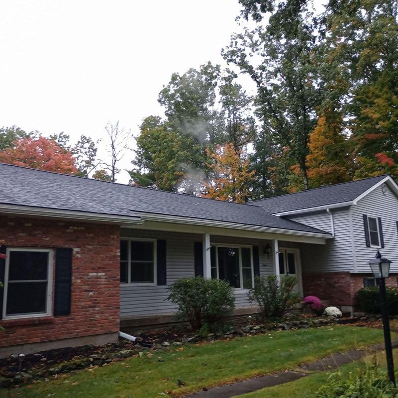 Shingle roof installation on residential home in autumn