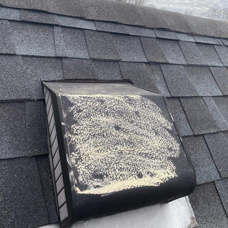 Roof vent with hail damage on asphalt shingles