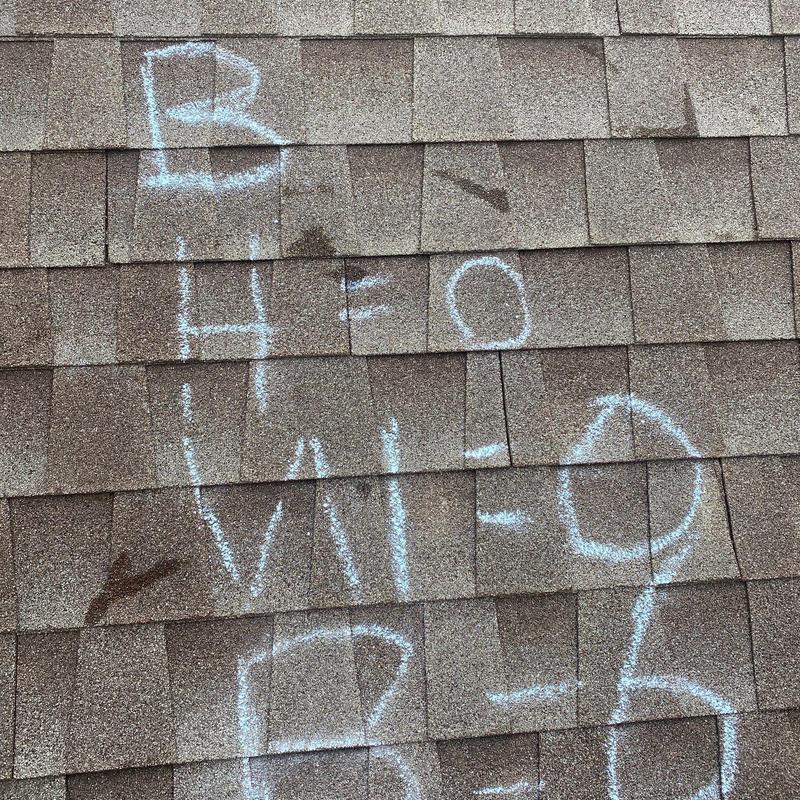 Asphalt shingle roof with hail damage markings