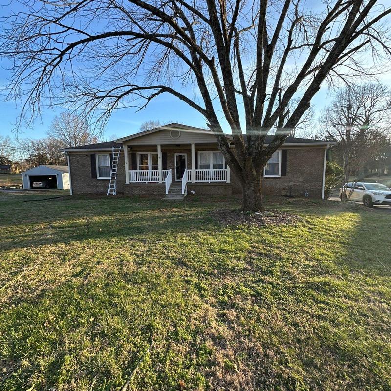 Roof ridge and flashing inspection with ladder on house
