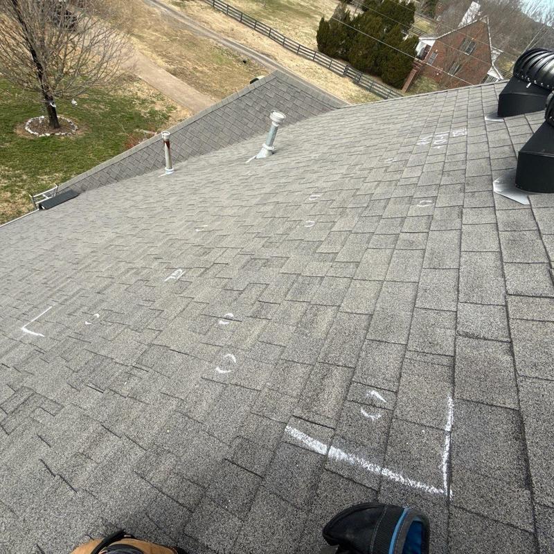 Asphalt shingle roof with marked hail damage spots