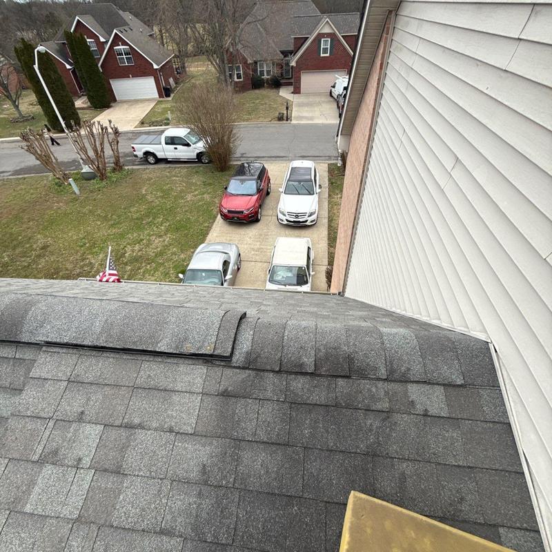 Asphalt shingle roof with ridge cap and flashing inspection