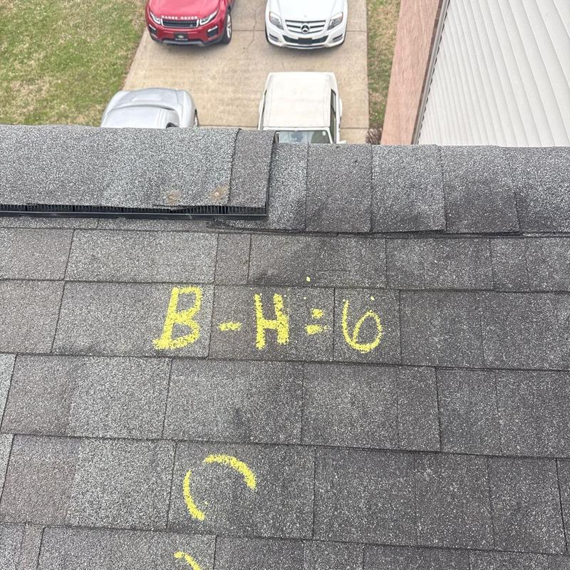Asphalt shingle roof with hail damage markings