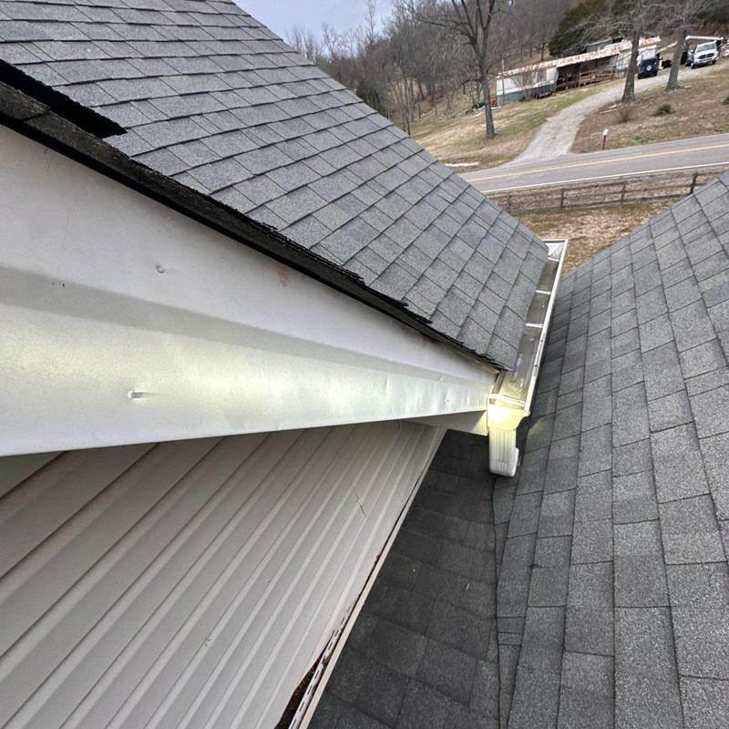 Roof shingles and gutter joint with hail damage