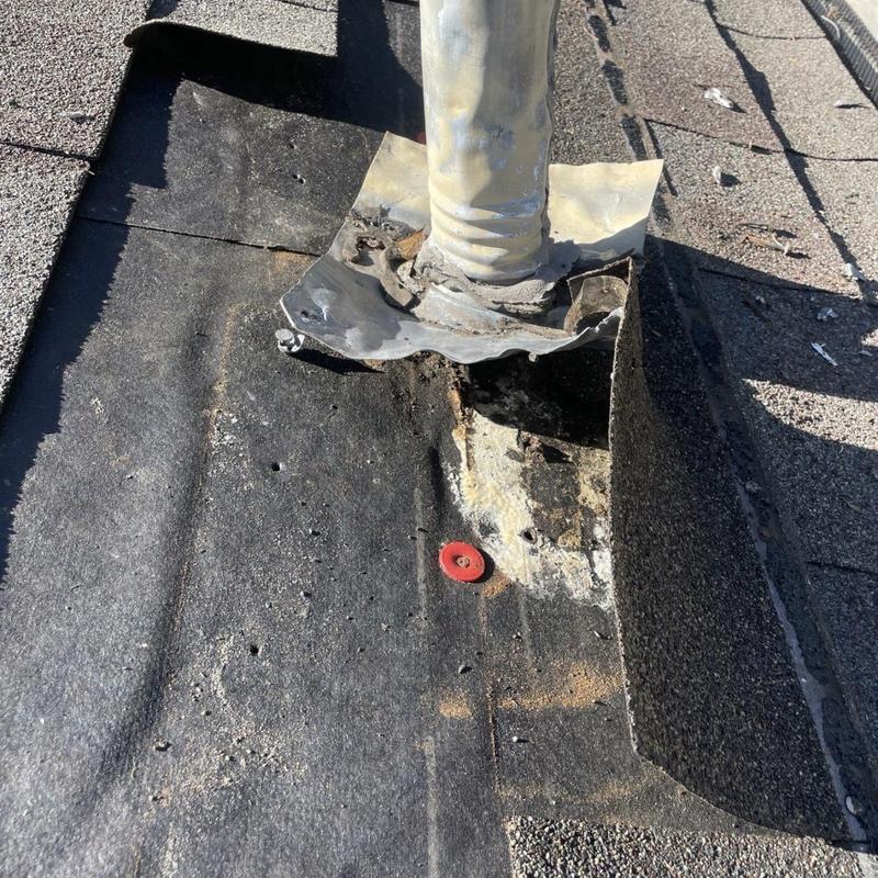 Pipe flashing with damaged roof and missing shingles