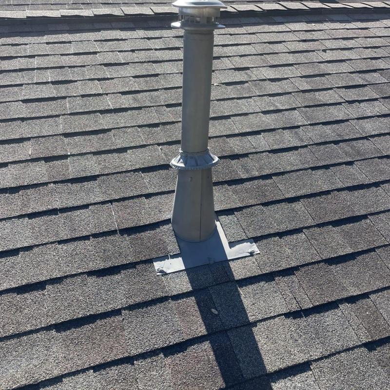 Metal roof vent pipe flashing on asphalt shingle roof