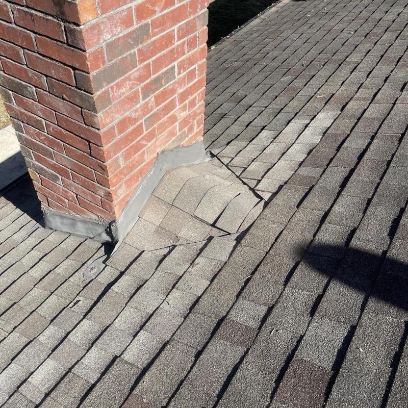 Chimney flashing and roof shingle repair on asphalt roof
