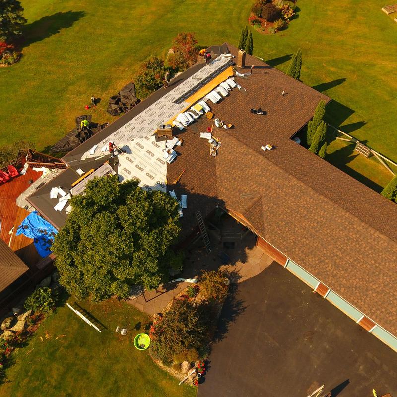 Asphalt shingle roof installation on lakeside home