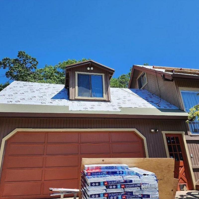 Asphalt roof underlayment installation on house roof