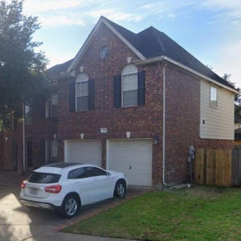 Roof and gutter system on brick home in Katy, TX