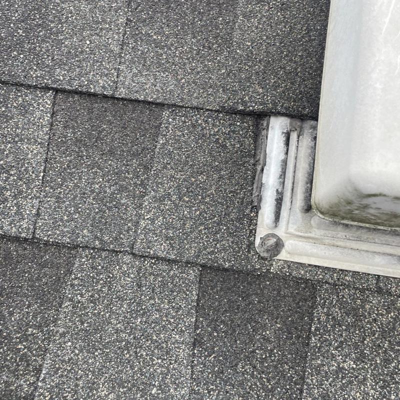 Roof shingles around metal vent flashing on residential roof