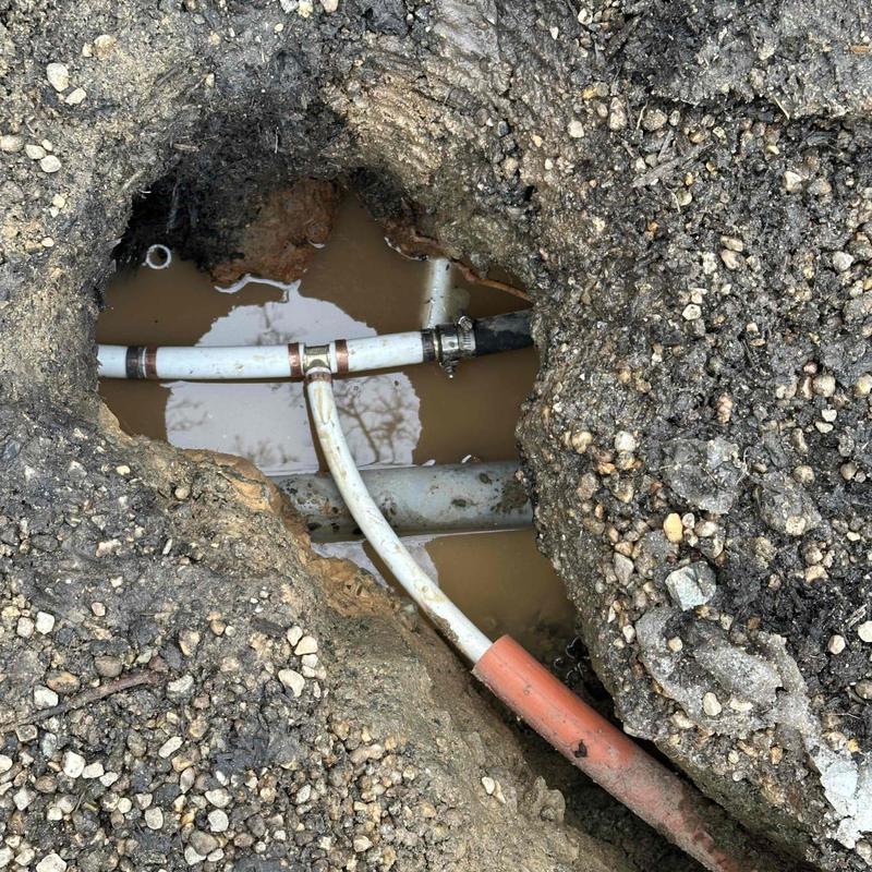 Underground plumbing pipes in muddy excavation site Underground plumbing pipes in muddy excavation site