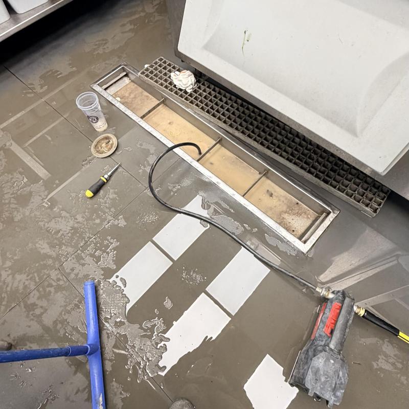 Trench drain with sewer snake clearing blockage