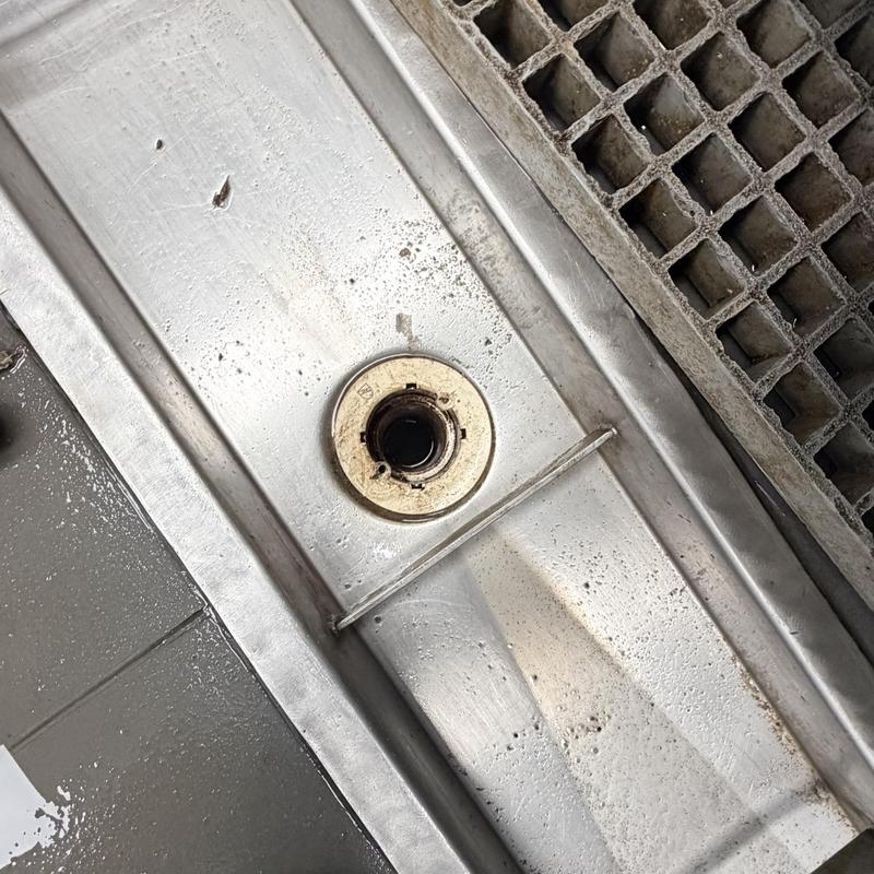 Trench drain with cleanout and metal grate nearby