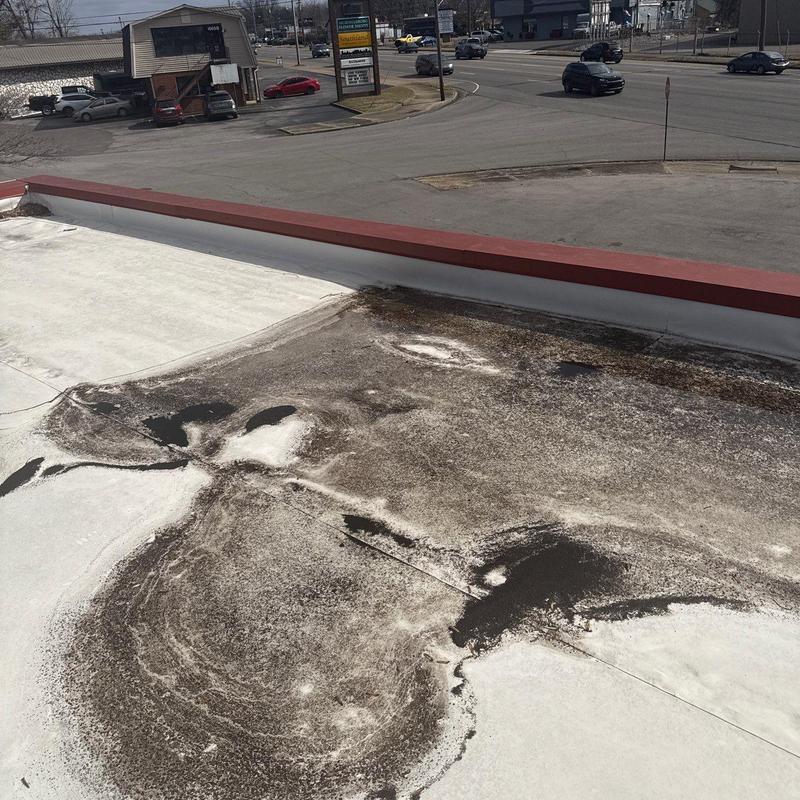 Flat roof membrane with extensive surface damage and wear