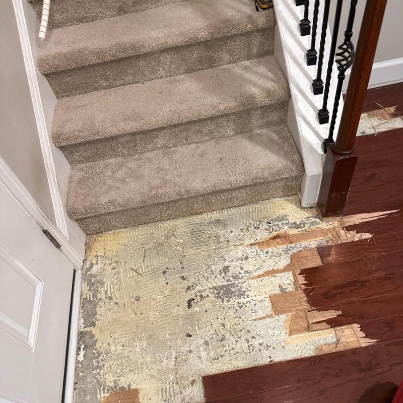 Hardwood floor near stairs with partial removal