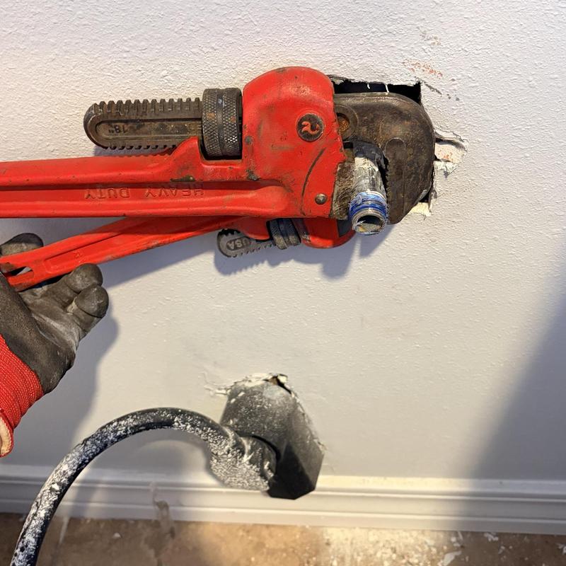 Gas dryer supply line installation with pipe wrench