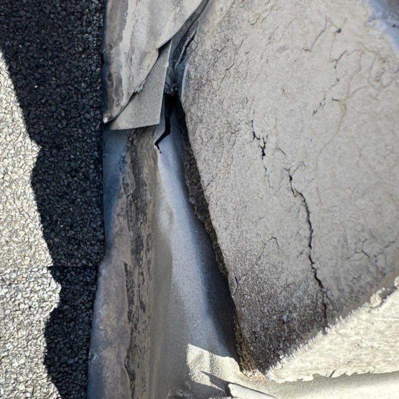 Roof flashing with cracks and sealant damage