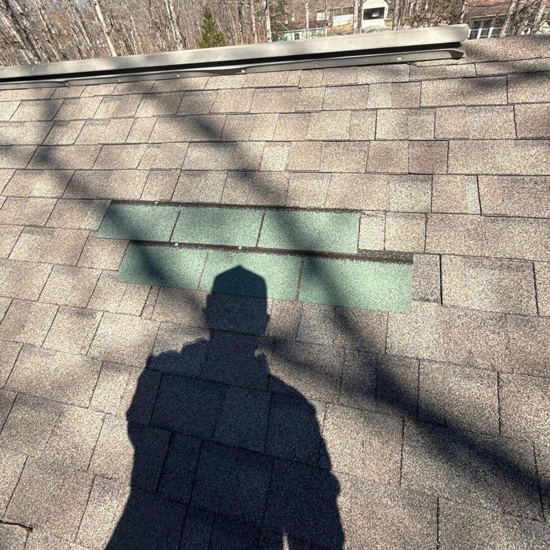 Roof shingles with hail damage and patch replacement
