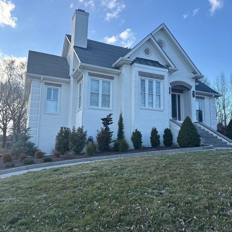 Roof shingles hail damage inspection on white home