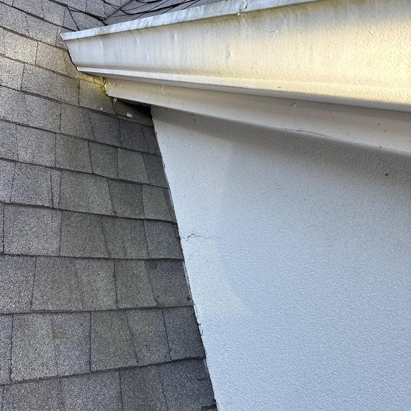 Roof shingles with gutter and wall flashing detail