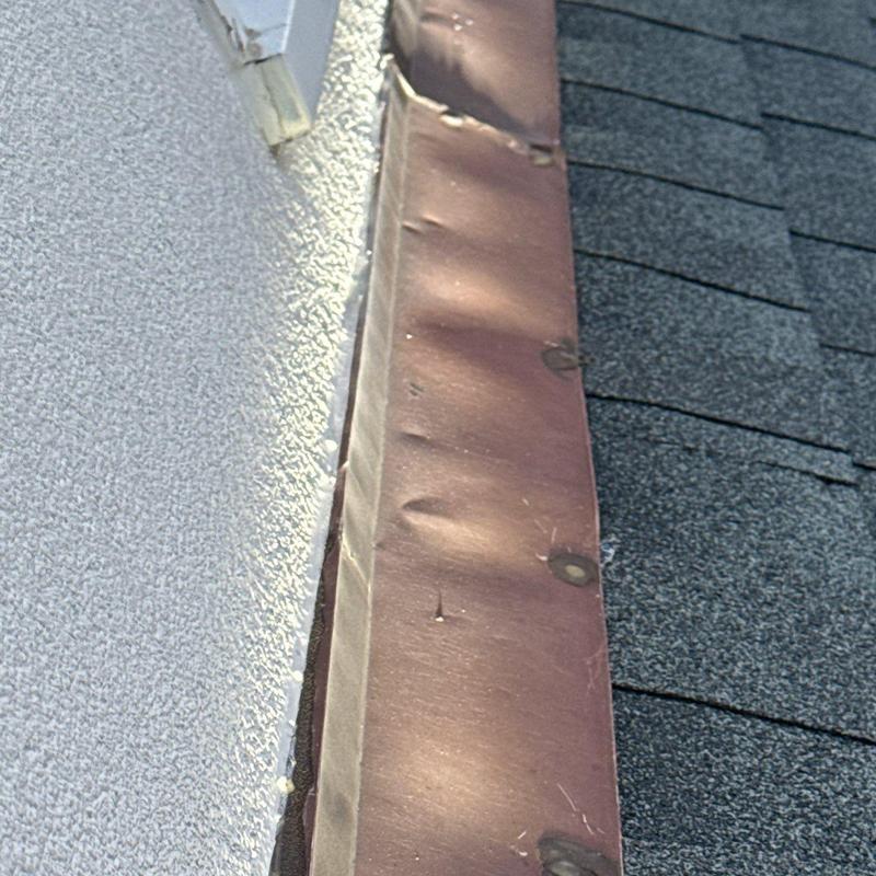 Metal roof flashing dents and nail heads closeup