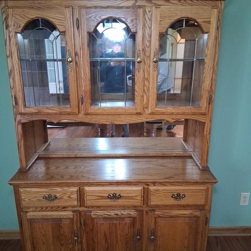 Wooden china cabinet with glass doors in dining room Wooden china cabinet with glass doors in dining room