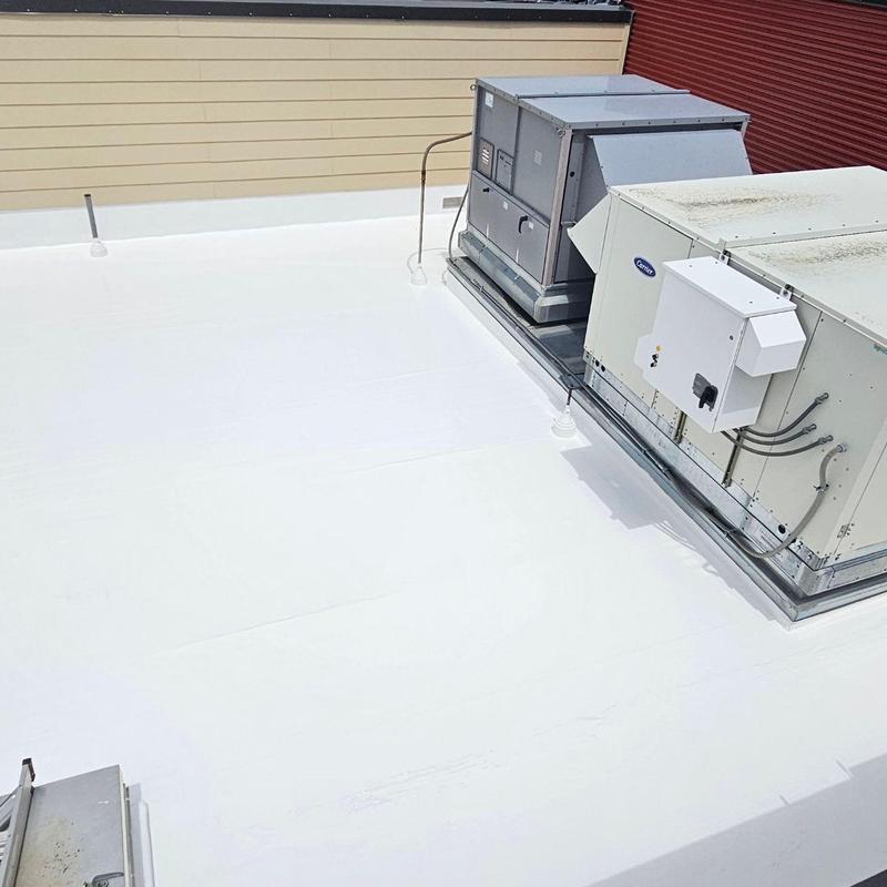 Flat roof silicone coating with HVAC units installed Flat roof silicone coating with HVAC units installed