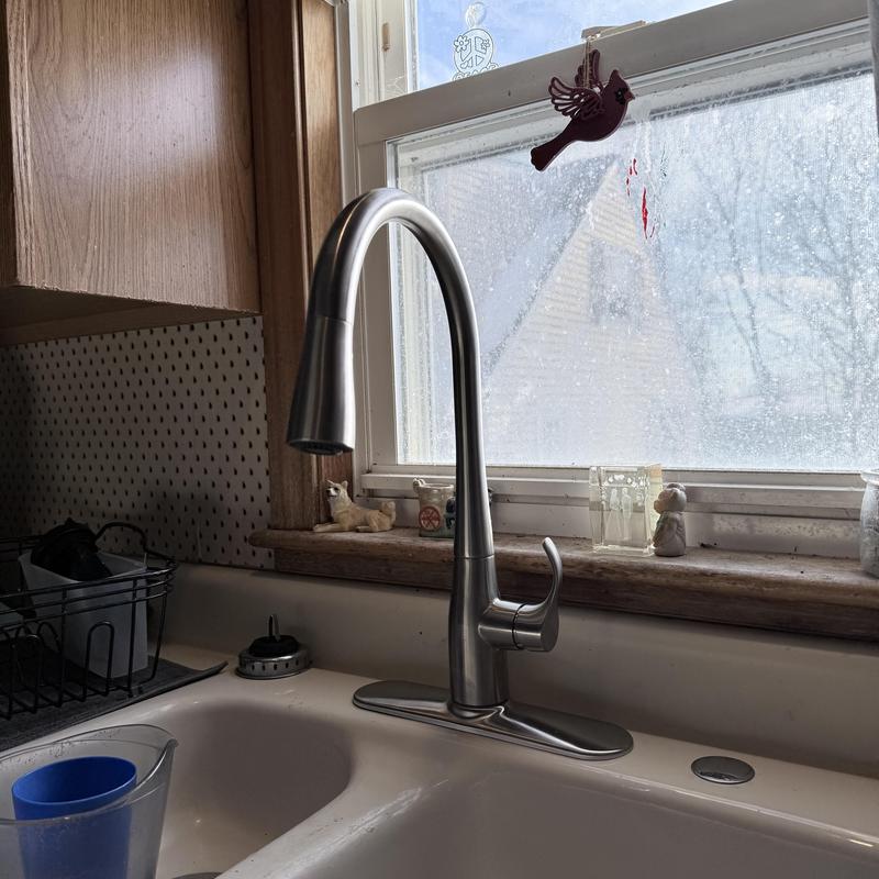 Kitchen faucet installation near window and sink