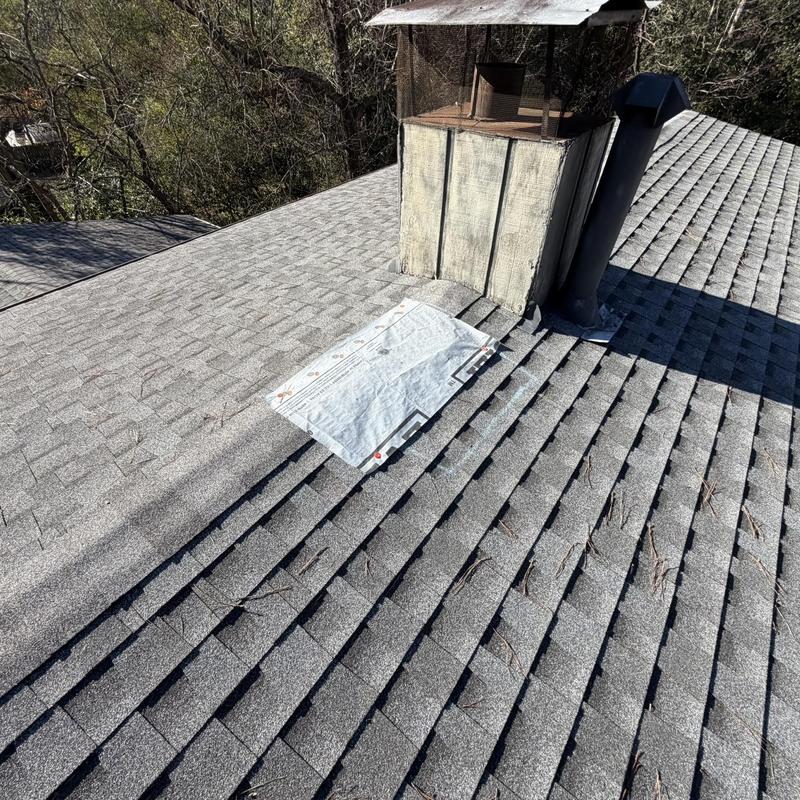 Roof shingles and ridge caps with new flashing installed