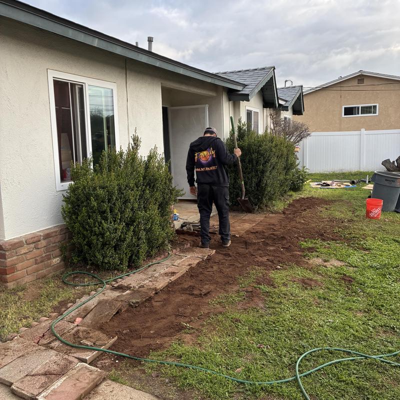 Cast iron sewer line excavation near house exterior
