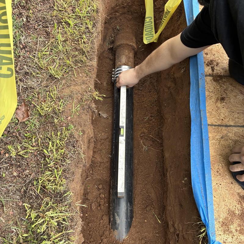 Cast iron sewer pipe with level during sewer dig-up