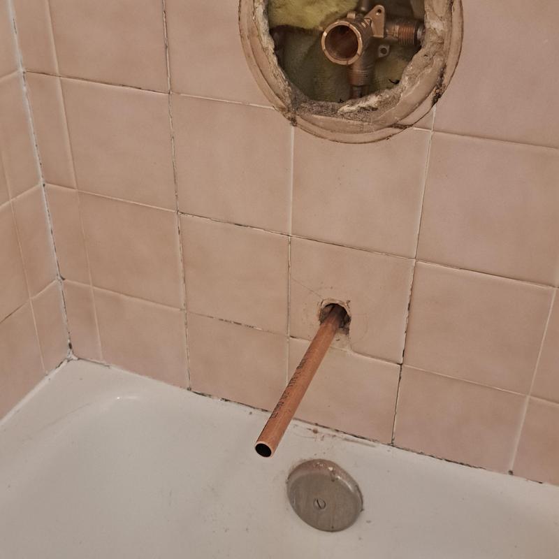 Shower valve and spout plumbing installation in bathroom wall