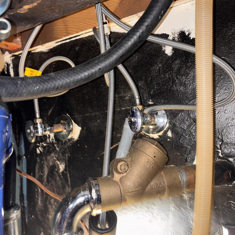 Angle stop valves with new escutcheons under kitchen sink