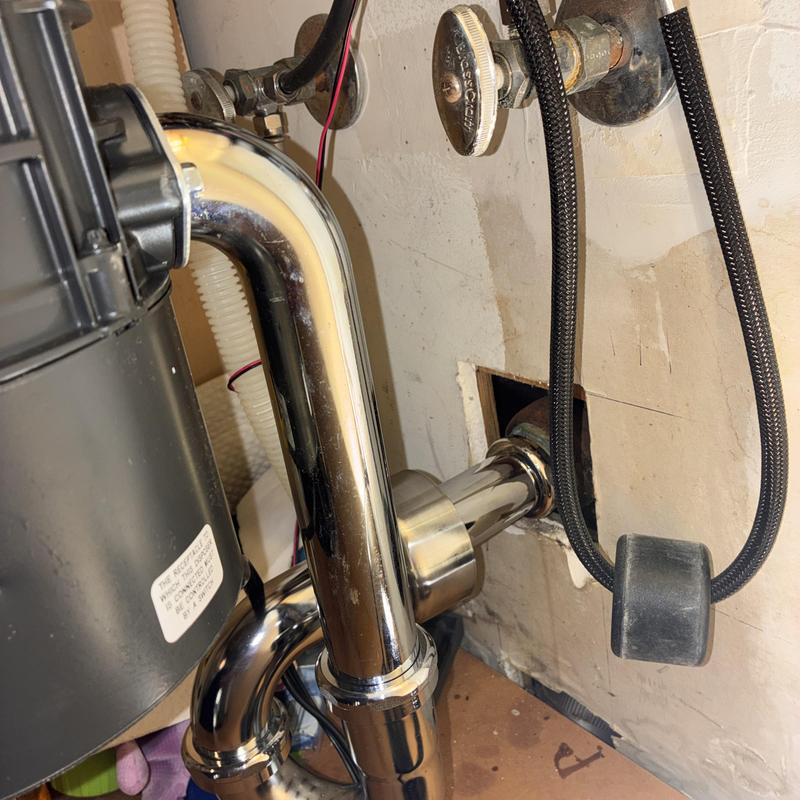 Garbage disposal and chrome P-trap installation under sink