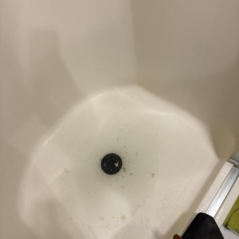 Shower drain with debris before cleaning