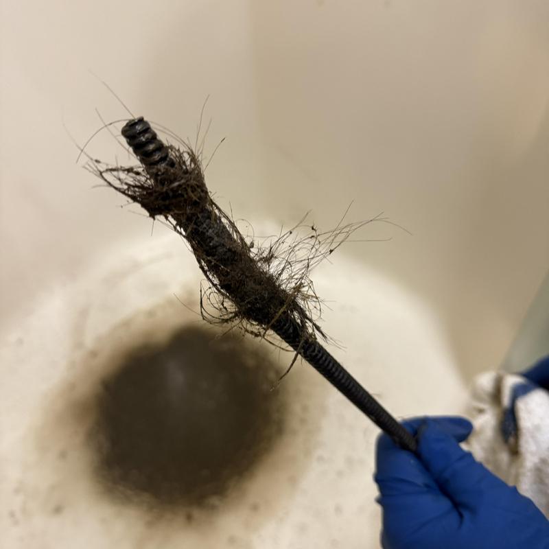 Shower drain cable with hair clog removed