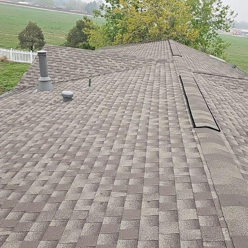 Asphalt shingle roof with vents and ridge caps