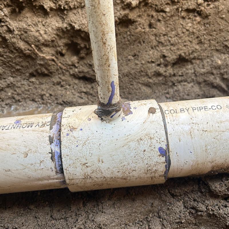 PVC water main pipe tee with new fittings in soil