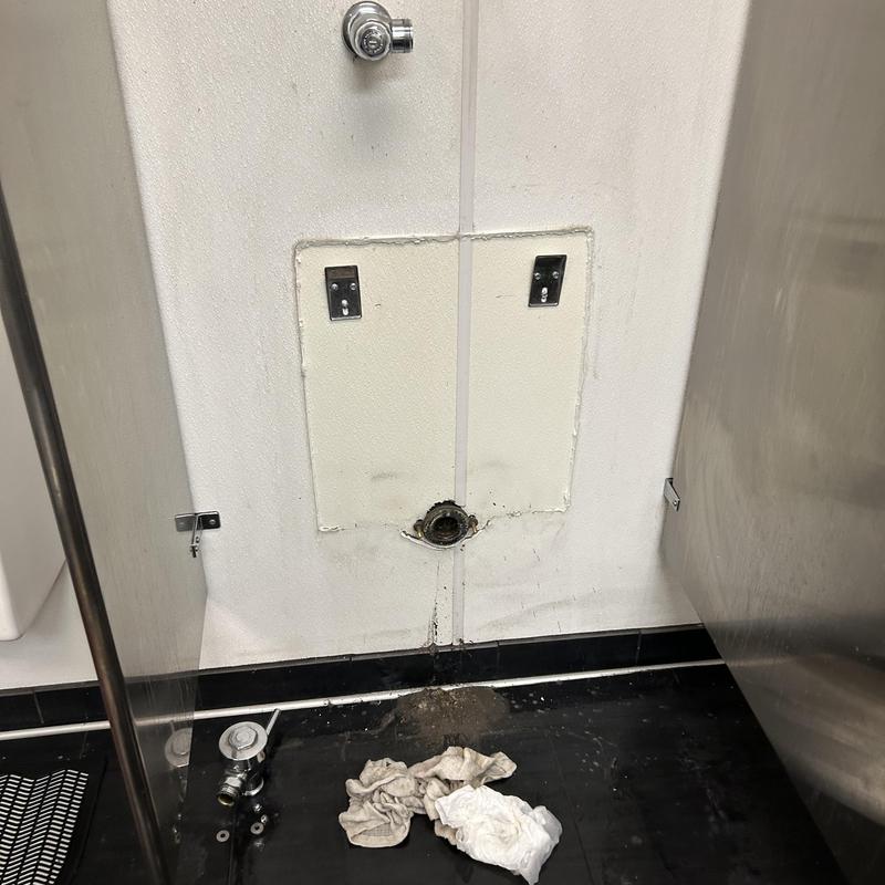 Urinal drain flange dismounted for clog removal