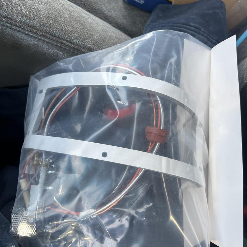 Water heater pilot assembly with wiring in plastic bag