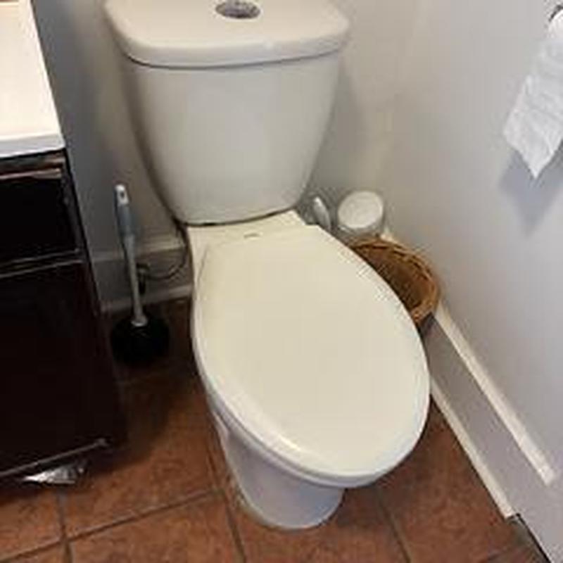 Toilet installation in tiled bathroom corner