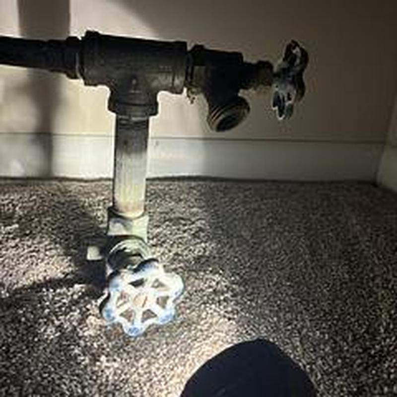 Outside hose faucet pipe with shutoff valves under sink