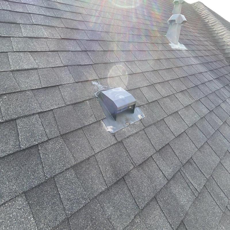 Dryer vent with new flashing on asphalt shingle roof