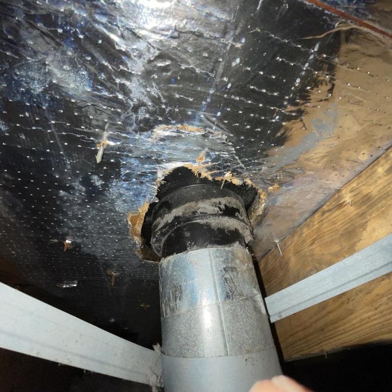 Dryer vent pipe with damaged roof flashing and ceiling damage