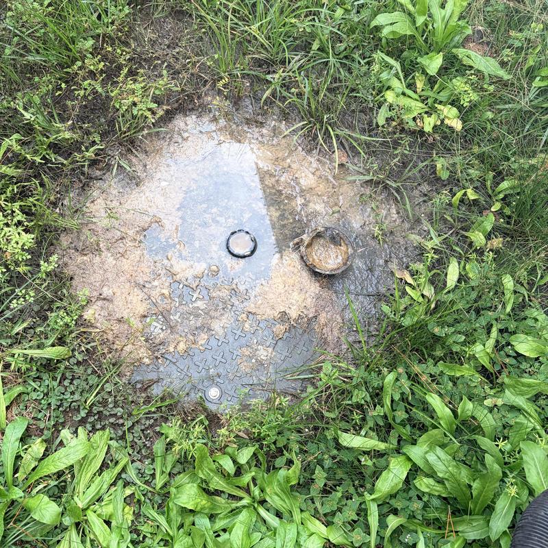 Grinder pump basin flooded with sewage backup and debris